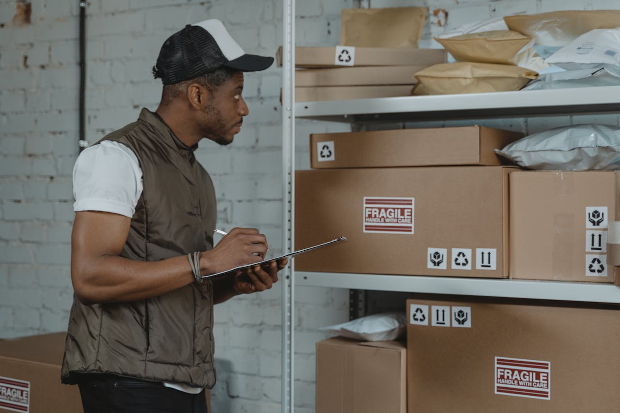 Courier checking packages in a warehouse, ensuring fragile handling